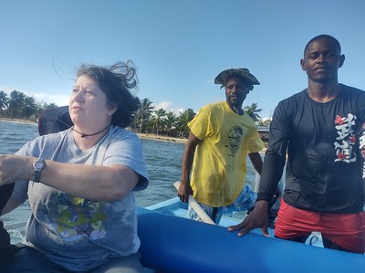 Jayne is in a boat with the guides for
        the day of snorkeling