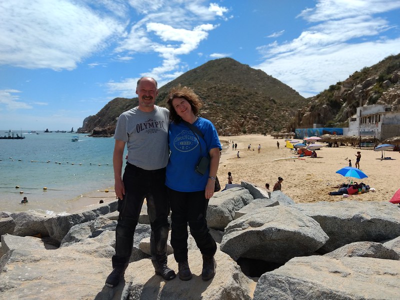 Man and woman on
        beautiful, sunny beach net to water